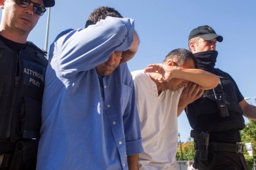 Two of the eight Turkish soldiers who fled to Greece in a helicopter and requested political asylum after a failed military coup against the government, are brought to prosecutor by two policemen in the northern Greek city of Alexandroupolis, Greece, July 17, 2016. REUTERS/Vasilis Ververidis/Eurokinissi GREECE OUT. NO COMMERCIAL OR EDITORIAL SALES IN GREECE. TPX IMAGES OF THE DAY