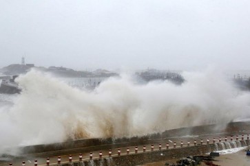 Waves crash into a pier in Hui'an county in Quanzhou, east China's Fujian province on September 29, 2015. Super typhoon Dujuan has killed three people and left more than 300 injured in Taiwan, authorities said on September 29 after it swept across the island before making landfall in eastern China. It hit the Chinese coastal city of Putian by afternoon, state news agency said, but there were no immediate reports of damage. CHINA OUT     AFP PHOTO        (Photo credit should read STR/AFP/Getty Images)