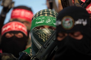 Palestinians militants from various armed factions, including Hamas, attend a news conference in Gaza City June 17, 2014. The news conference was held to protest against Israeli arrest of Palestinians in the West Bank as well as to show support for people in the West Bank and Hebron. Photo by Ashraf Amra